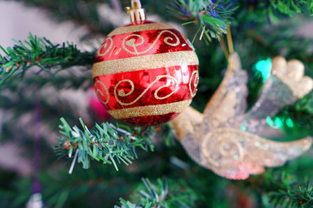 Beautiful, colorful, Christmas toys on an artificial Christmas tree, with a blurry background.の写真素材