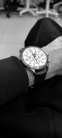 Close up of a man's wristwatch in black and white.の写真素材
