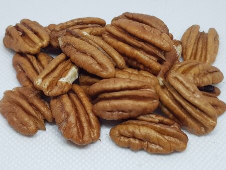 A bunch of walnuts on a white backgroundの写真素材