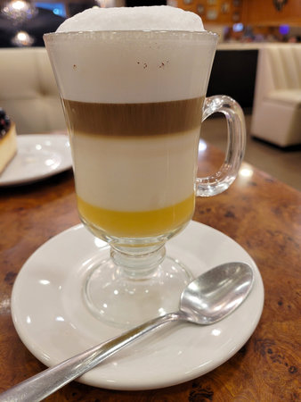 Drinking coffee in the restaurant, cup of coffee with eggnog