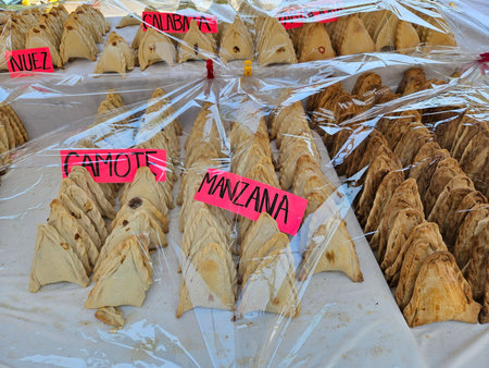 A table full of different shaped pastries with labels on them. The labels says Nuts, Sweet potato...