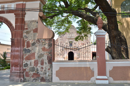 Villa Corona, Mexico - May 11 2024: View of the temple of the town. The archway is made of stone and has a gateのeditorial素材