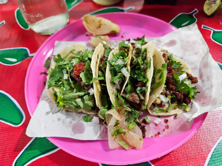 Order of steak tacos with chorizo on a pink plate at a street stall, mexican foodの写真素材