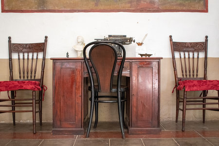 Historic wooden desk with classic chairs, typewriter and decor inside a traditional room in Cocula, Jaliscoの写真素材