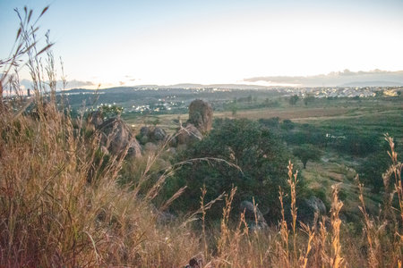 Panoramic view toward the iconic El Diente rock formation in Zapopan, Jalisco, surrounded by fields and greeneryの写真素材