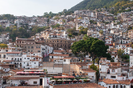 A scenic view of Taxco, Guerrero, Mexico, showcasing its iconic hillside filled with colonial-style buildings and vibrant rooftopsの写真素材