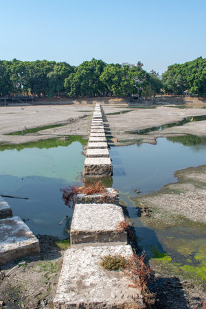 Elevated stone bridge over partially dry pond in El Dean Park, Guadalajara, Jalisco, Mexicoの写真素材