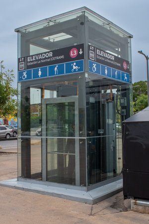 Guadalajara, Mexico - May 29 2025: Transparent glass elevator for accessibility and transport connection at CETRAM station, Glorieta de la Normal, Guadalajara, Jaliscoのeditorial素材
