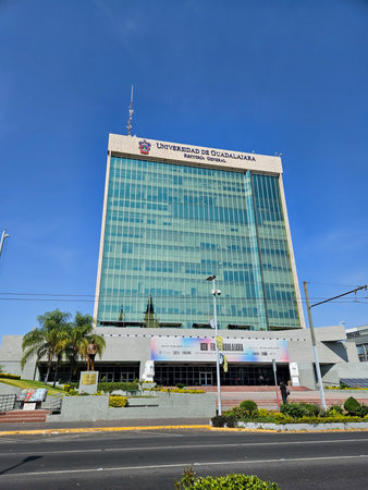 Guadalajara, Mexico - November 10 2024: Modern glass skyscraper of the University of Guadalajara Rectorate Tower under a clear blue sky. Urban architectureのeditorial素材