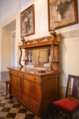 Cocula, Mexico - April 27 2025: Elegant antique sideboard with glassware and mirror inside a traditional hacienda in Cocula, Jaliscoのeditorial素材