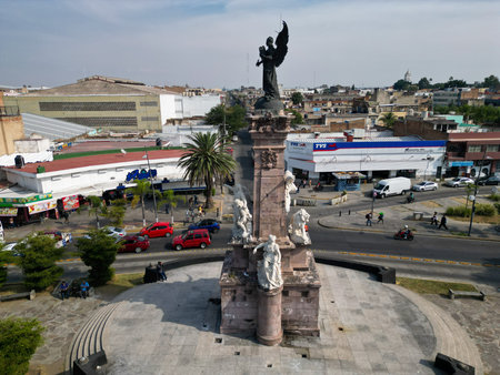 Guadalajara, Mexico - November 8 2025: Aerial perspective of Guadalajara's Independence Monument. Historic landmark situated in a city intersection with traffic and urban buildingsのeditorial素材