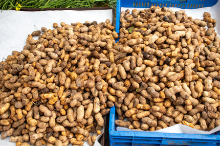 Large amount of unshelled peanuts spread over crates at a traditional market in Guadalajara, Jalisco