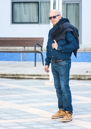 Man with glasses smiling in front of the camera, a happy manの写真素材