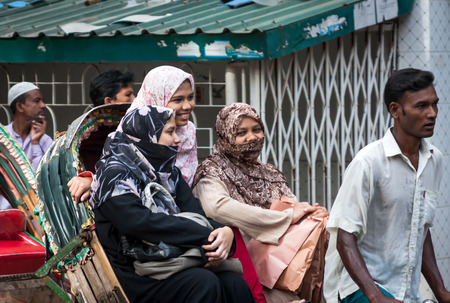 AUGUST 10,2012-DHAKA, BANGLADESH  The photo was taken on a street in Dhaka, we can see some girls assembled in typical country transportationのeditorial素材