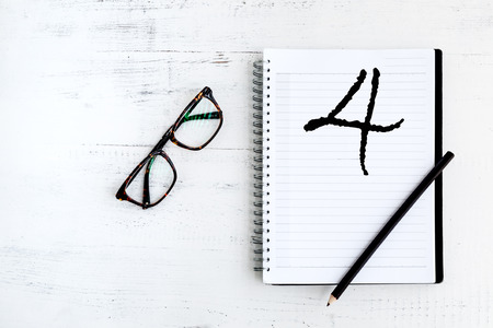 Notebook with written number fourの写真素材