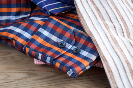 Men\'s shirts on wooden tableの写真素材