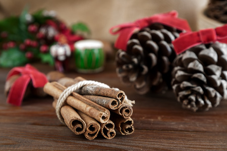 Christmas decoration on wood and woven sack with candles and all kinds of Christmas items and fruitsの写真素材