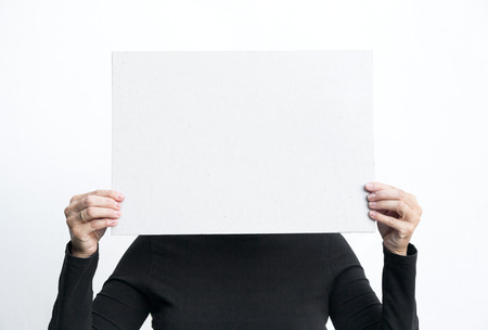 Beautiful brunette woman doing all kinds of gestures and emotions with blackboard isolated on white backgroundの写真素材