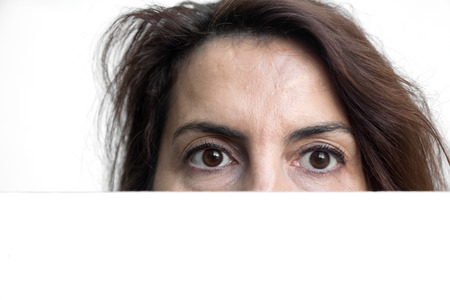 Beautiful brunette woman doing all kinds of gestures and emotions with blackboard isolated on white backgroundの写真素材