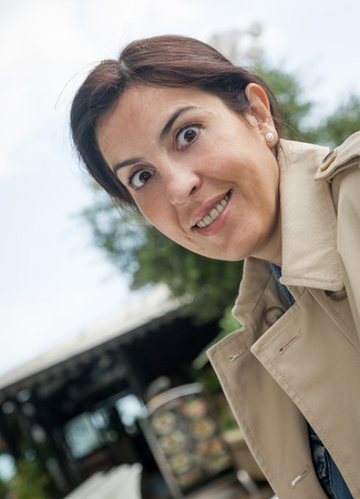 Brunette woman working outside with phone and tabletの写真素材