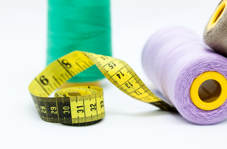 Sewing utensils, scissors, threads and buttons colors isolated on white backgroundの写真素材