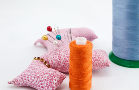 Sewing utensils, scissors, threads and buttons colors isolated on white backgroundの写真素材