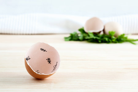 Eggshells with parsley on wooden board