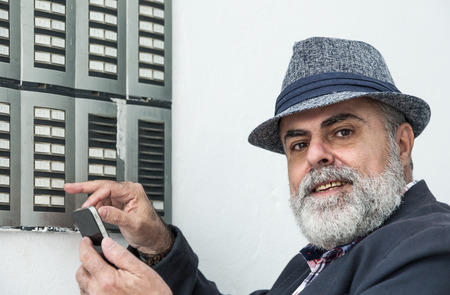 Attractive man 50 years old with beard and hatの写真素材