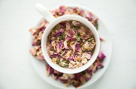 Roses in cup with water focused and unfocusedの写真素材