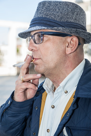 Man with glasses smiling in front of the camera, a happy manの写真素材