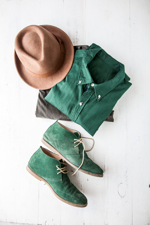 Set of clothes and various accessories for men on old wooden tableの写真素材