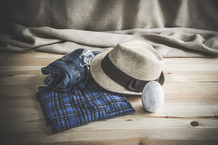 Set of clothes and various accessories for women on old wooden tableの写真素材