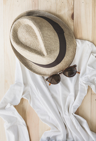 Set of clothes and various accessories for women on old wooden tableの写真素材