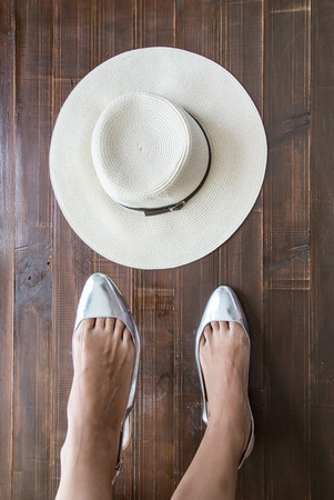 Woman legs putting on shoes with accessoriesの写真素材