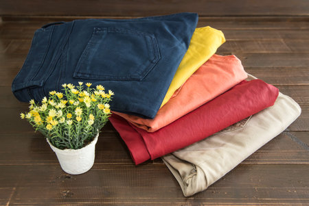 Set of clothes and various accessories for women on old wooden table
