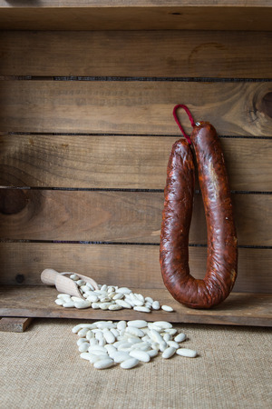 White beans with thyme and chorizo on old wooden tableの写真素材