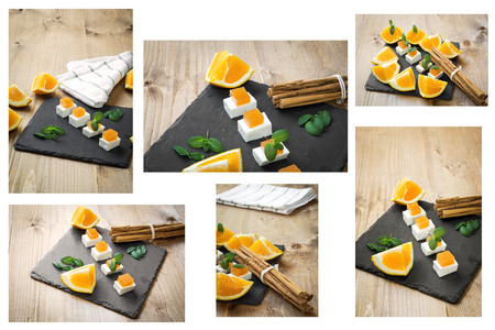 Snack cheese with quince and fresh oranges on old wooden tableの写真素材