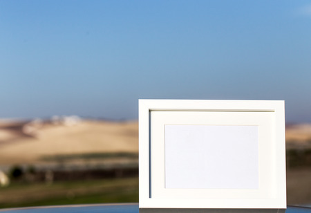 White photo frame with the background scenery and streetsの写真素材
