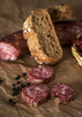 Close-up of sausage pieces with fresh bread on paperの写真素材