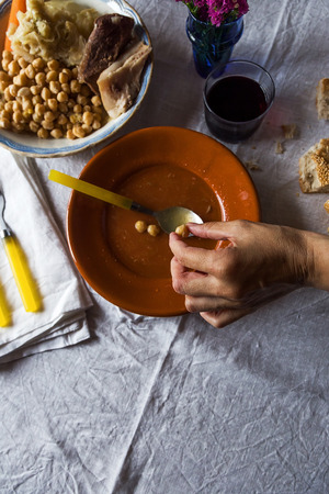 Cooked hot soupe and other food on table with yellow utensils.From aboveの写真素材