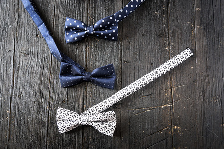 Dotted bow-tie on black shabby wooden floorの写真素材