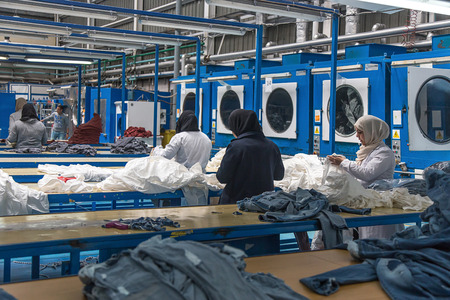 Tangier, Morocco-April 18,2016:In the picture we can see an industrial laundry with workers, washing machine, dryers, laboratory and boilers.のeditorial素材