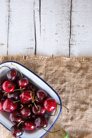 Red fresh cherries on old wooden tableの写真素材