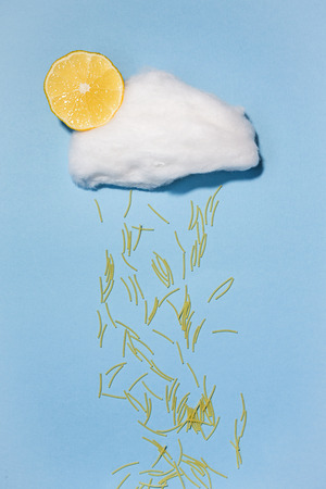 Cloud made of cotton candy with sugar food on blue background rainの写真素材