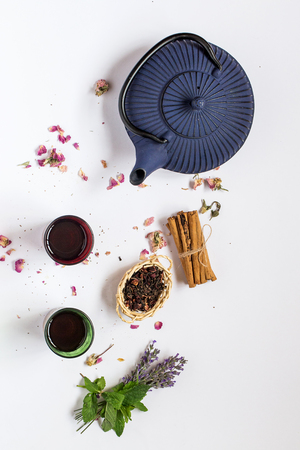 Arabic nana mint tea in traditional glass with mint, cinnamon, anise stars and almond and chocolate cakeの写真素材