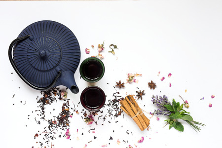 Arabic nana mint tea in traditional glass with mint, cinnamon, anise stars and almond and chocolate cakeの写真素材