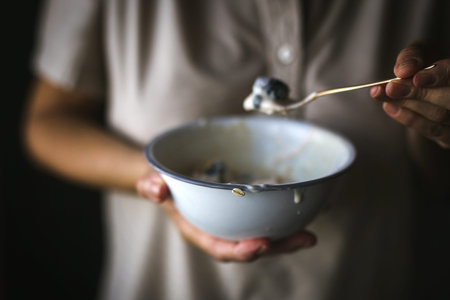 unrecognizable woman in a red dress holding a smoothie in handの写真素材