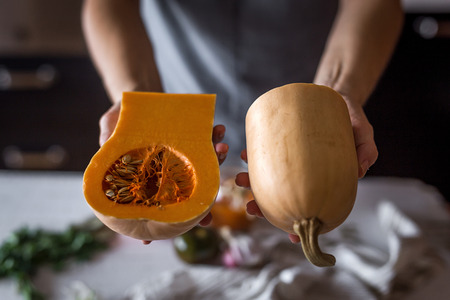 Unrecognizable woman in a halloween pumpkin soup in handの写真素材