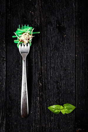 Italian pasta with tomato and basil on fork On wooden boardの写真素材