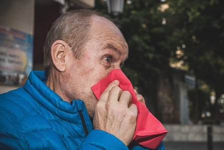 Senior Man eating on the terrace of a restaurant outsideの写真素材